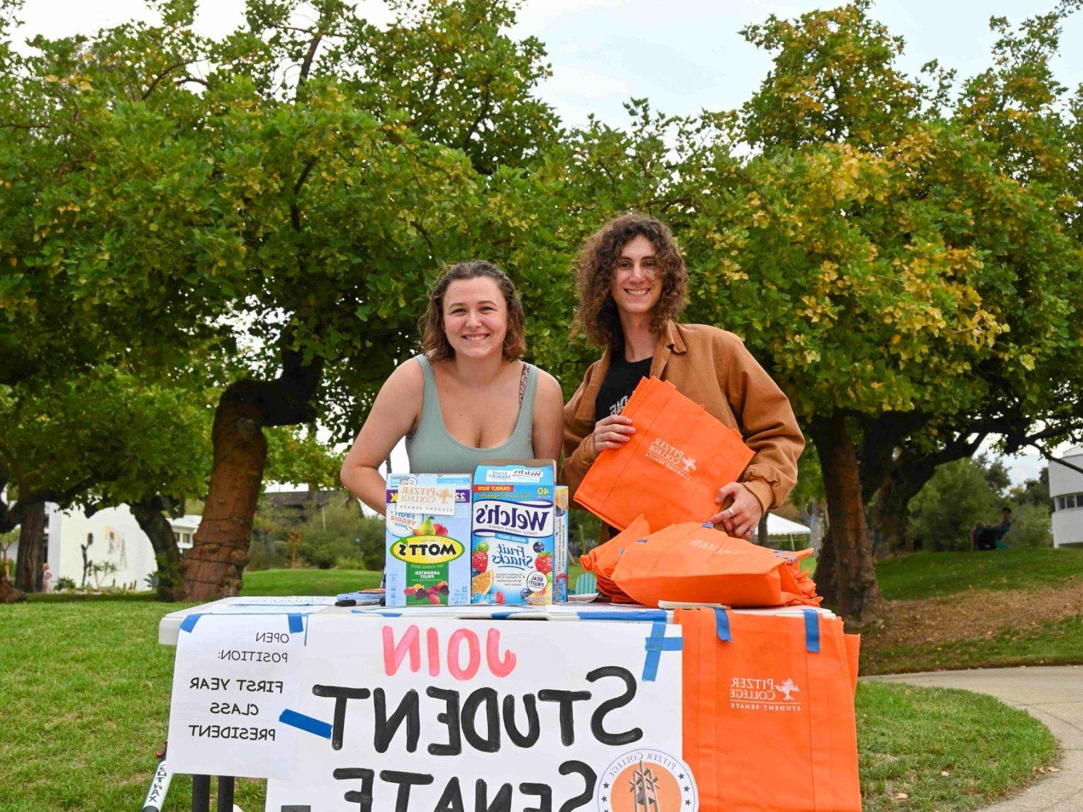 Two students at the join student senate table