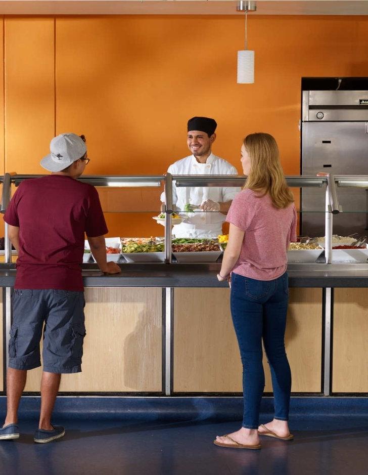 Pitzer students talk with a chef in McConnell Dining Hall